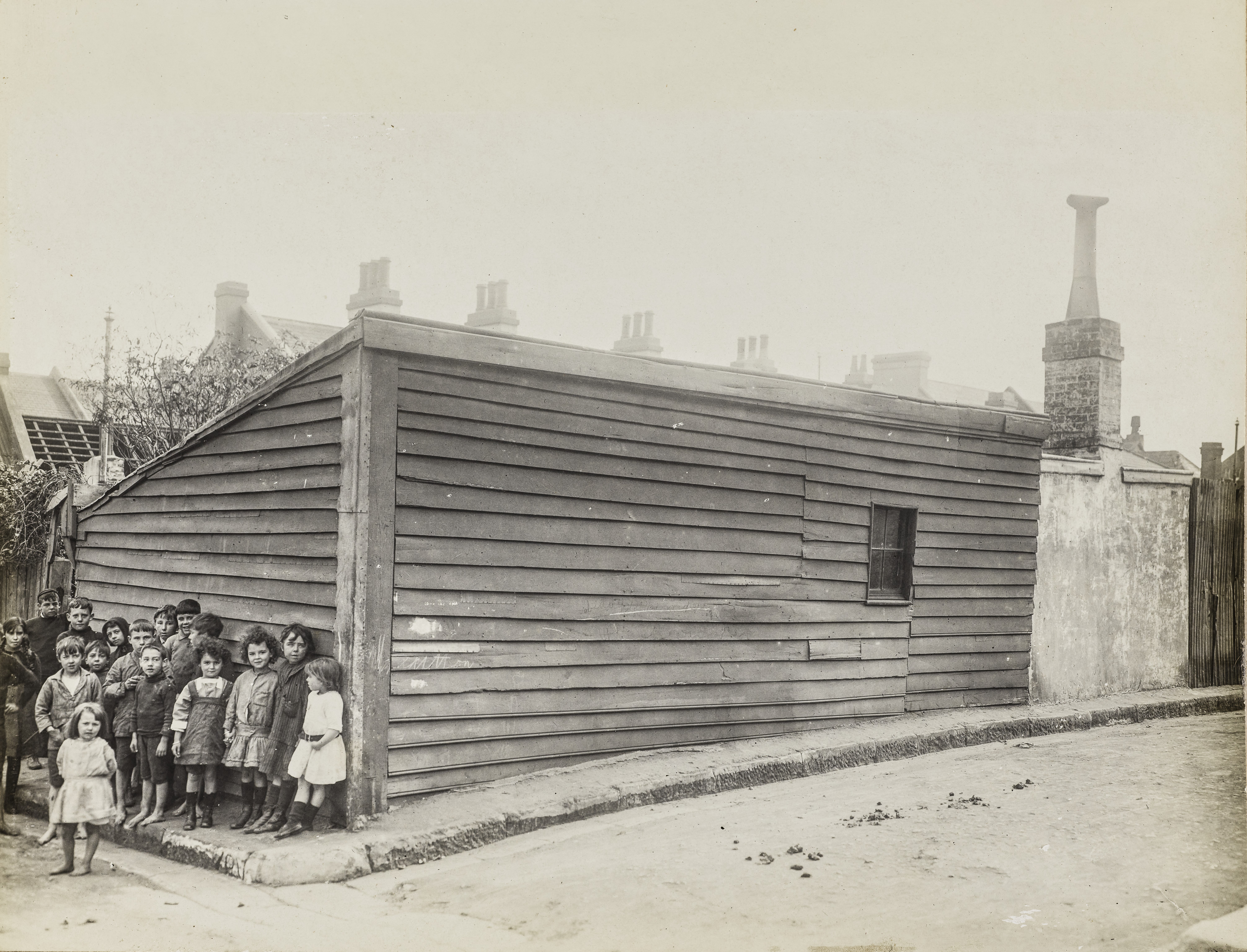 Photograph showing children in front of timber building